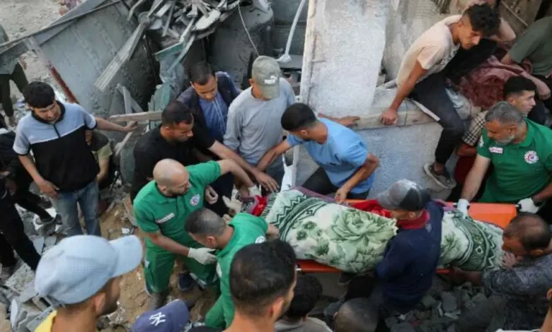Palestinians Carry Body from Wreckage of Israeli Strike in Gaza